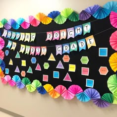 a bulletin board decorated with colorful paper umbrellas