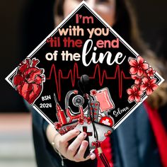 a woman holding a graduation cap that says i'm with you till the end of the line