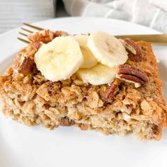 a white plate topped with oatmeal and banana slices next to a fork