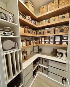 an organized pantry with lots of items in baskets and bins on the shelves,