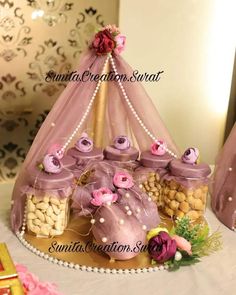 a pink tent with lots of candy and candies in it sitting on top of a table