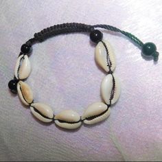 Shop This Beautiful African Cowrie Shell Bracelet. Brand New Handmade Black Braided Bracelets For Beach, Black Beaded Braided Bracelets For Beach, Black Beaded Jewelry For Vacation, Casual Black Braided Bracelets For Beach, Handmade Black Beaded Bracelets For Vacation, Black Bracelet With Sliding Knot For Beach, Casual Black Beaded Bracelets For Beach, Handmade Black Jewelry For Vacation, Casual Black Beach Jewelry