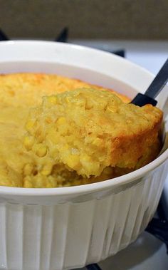 a white bowl filled with food on top of a stove