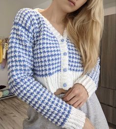 a woman wearing a blue and white sweater