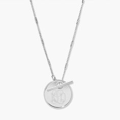 An engravable disc pendant is the centerpiece of our stylish toggle monogram necklace. This is the perfect everyday piece for work, play, and everywhere in between. Available in 14k gold plated, rhodium plated or 14k rose gold plated brass Pendant size: 7/8" 18" curb barrel chain Toggle closure Made in the USA With engraving this item is FINAL SALE SKU: BYN1171 Classic Sterling Silver Toggle Necklace, Elegant Silver Medallion Necklace For Everyday, Elegant Everyday Engraved Medallion Necklace, Elegant Silver Toggle Necklace With Round Pendant, Elegant Medallion Jewelry With Toggle Clasp, Classic Necklace With Engraving Option, Elegant Sterling Silver Medallion Necklace For Everyday, Elegant Medallion Toggle Necklace, Modern Sterling Silver Toggle Necklace As Gift