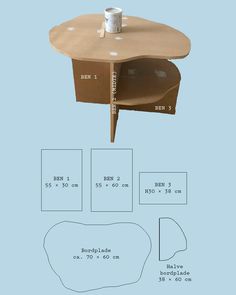 the table is made out of cardboard and has a coffee cup on it with measurements