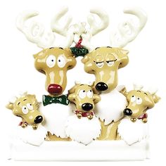 a group of reindeer figurines sitting next to each other on a white surface