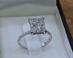 an engagement ring with a princess cut diamond