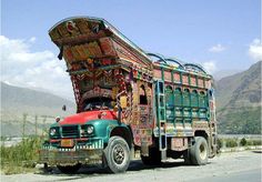 the truck is decorated with colorful designs on it's sides and has an open hood