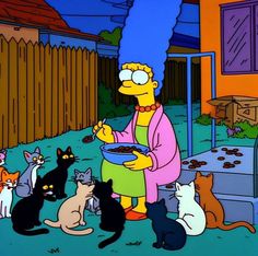 the simpsons eating out of a bowl with many cats around it in front of him