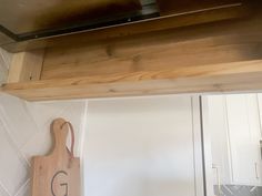 a wooden cutting board sitting on top of a kitchen counter