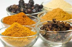 several bowls filled with different types of spices