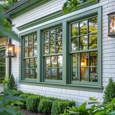 a white house with green trim and windows