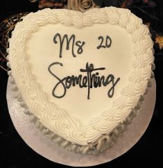 a heart shaped cake with the words'mrs 20 something'written in black on it