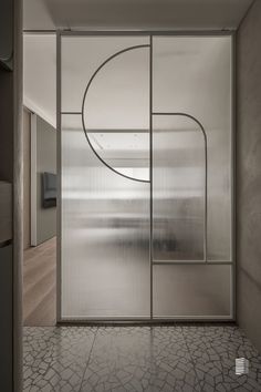 an open glass door with a circular design on it