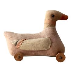 a stuffed duck is sitting on wheels