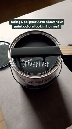 a paint can with the words olive black written on it next to a pair of scissors