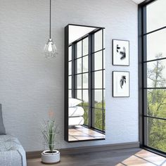 a living room filled with furniture and lots of window panes on the wall next to a couch