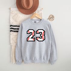 Custom Baseball Number Sweatshirt or Hoodie, Baseball Sweatshirt, Baseball Hoodie, Personalized Hoodie, Custom Sweatshirt, Softball Hoodie CAUTION: For security reasons, there is no rope in the throat area for youth hoodie. Hello!! Dear Customer, We're here to give you best Custom Sport  sweatshirt, hoodie and crewneck options for you. We want to make everyone smile with our cute , stylish and trendy graphic T-shirts. We can assured you this shirt will be perfect Custom Sport sweatshirt, hoodie Fleece Hoodie Sweatshirt For Sports, Sportswear Hoodie Sweatshirt For College, Fan Apparel Hoodie For Sports Events, Team Spirit Hoodie For Sports Season, Winter Long Sleeve Sports Fan Hoodie, Sportswear Hoodie Crew Neck For Sports Season, Collegiate Streetwear Sweatshirt For Baseball Season, Collegiate Crew Neck Hoodie For Sports, Sports Fan Long Sleeve Hoodie For Winter