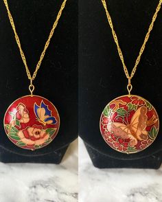 Vintage red floral butterfly reversible cloisonné enamel round puffy pendant on 18K gold plated wave chain. Each side is a different design! The head pin and jump ring are 18K gold plated. Necklace drop length of about 22-23 cm as the default chain. Comes in a box. Please keep in mind that the pendant itself is vintage so it may show some signs of age/wear which includes any signs of chipping or tarnishing. If you need a chain of another length, please select in the menu. If you need a chain len Gold Hand-painted Round Pendant Necklace, Red Enamel Round Pendant Necklace, Red Butterfly-shaped Jewelry Gift, Red Butterfly Jewelry For Gift, Red Enamel Jewelry With Large Pendant, Red Butterfly Necklace For Gift, Red Enamel Round Necklace, Unique Red Enamel Necklaces, Red Hand Painted Pendant Necklaces