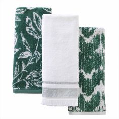 three green and white towels on top of each other