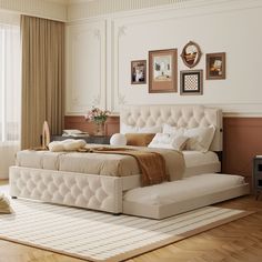 a large white bed sitting on top of a wooden floor next to a window covered in curtains