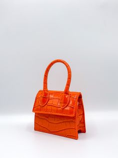 This mini bag is a super cute addition to any weekend look. Featuring bright orange material and a strap, its sure to make a statement. Style with more bright tones for a look that will turn heads. Orange Purse Aesthetic, Barbie Premiere, Orange Bags, Orange Accessories, Bright Bag, Statement Bags, Fancy Stuff, Orange Purse, Wig Party