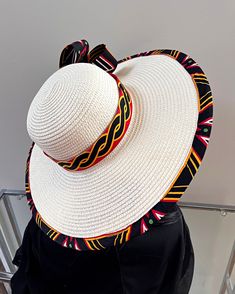 ombines timeless elegance with vibrant cultural flair. Handcrafted with care, this hat features a beautifully woven straw base adorned with bold African print fabric, offering both style and sun protection. Perfect for church services, outdoor events, or simply adding a touch of sophistication to your outfit, this hat blends tradition with modern design. Lightweight and breathable, it's as comfortable as it is striking. Elevate your look with a hat that celebrates heritage and craftsmanship. One size: should fit all. Ankara Bags, Juju Hat, Spice Gift, Mask Painting, African Print Fabric, Outdoor Events, African Fabric, Long Sleeves Jacket, Silk Chiffon