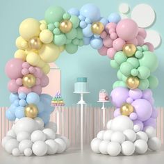 an arch made out of balloons in the shape of clouds