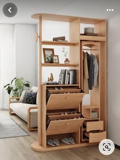 an open wooden closet with shoes and other items on the shelves next to a couch