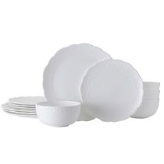 the white dishes are stacked on top of each other, with one bowl and two plates