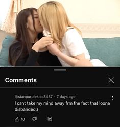 two women sitting on top of a couch kissing each other's foreheads,