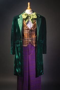 a green jacket and purple pants are on display