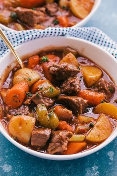 two bowls of beef stew with carrots and potatoes