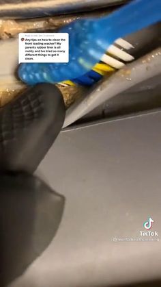 a pair of blue and yellow toothbrushes sitting on top of a sink