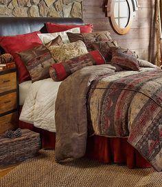 a bed in a room with pillows and blankets on top of the bedspread