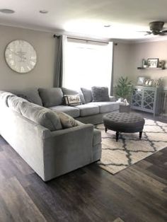 a living room filled with furniture and a fire place next to a wall mounted clock