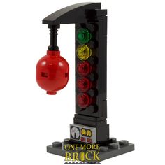 a lego light with a red ball hanging from it's side and the words one more brick above it