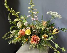 a vase filled with lots of different types of flowers