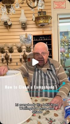 an older man sitting at a table with a lamp in front of him and the words how to clean a lampshade