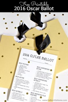 an oscars ball ticket with black and white polka dots on it, next to a gold envelope