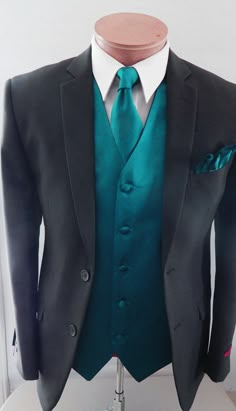 a mannequin wearing a suit and tie with a green shirt on it's lapel