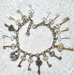 "Who has the key to your heart? Here's the perfect gift! A multitude of keys in many colors adorn this fun bracelet. There's Bronze, Silver, Rose Gold, Gold, KC Gold plus a heart lock! Infinity Adjust chain can be worn by children to adults up to 9\"; it can go on smaller ankles as well." Key Charm Bracelet, Trendy Gold-tone Metal Charm Bracelet, Nickel-free Gold Metal Charm Bracelet, Nickel-free Multicolor Metal Charm Bracelet, Sterling Silver Heart Bracelet, Gold-tone Metal Charm Bracelet With Vintage Charm, Ribbon Choker, Fun Bracelet, Chain Extenders