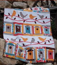 a quilted blanket with birds on it