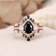 Pear Shaped Black Onyx engagement ring set 3pcs vintage Baguette Moissanite Diamond rose gold ring matching wedding band gift for women halo ✦ Handmade, high-quality item ✦ Material: SOLID 10K/14K/18K GOLD ( can be made in yellow/white/rose gold ) ✦Engagement ring ✦ Center stone: Black Onyx ✦ Size/Weight: 6*8mm ✦ Color: Black ✦ Cut: Pear Shaped ✦ Side stones: Natural Diamonds  ✦ Weight: About 0.436ct  ✦ Color: G-H ✦ Clarity: SI-VS ✦ Or Side stones Moissanite: 0.436ct ✦ Band Width: Around 1.6mm ✦ 6mm Wedding Band, Black Diamond Wedding Rings, Black Obsidian Stone, Black Onyx Engagement Ring, Onyx Engagement Ring, Ring Matching, Ring Rosegold, Moissanite Band, Diamond Wedding Rings Sets