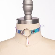 Classic choker collar in iridescent, holographic vinyl layered over PVC. An aurora borealis chandelier crystal point adorns the center o-ring. Fit is adjustable with buckle. Holes are reinforced with grommets.This is the mini version - slightly slimmer with a smaller crystal for a more delicate look!Collar is 1/2" wide, with a 1" crystal point.SMALL/MEDIUM (11-13")MEDIUM/LARGE (13-15")LARGE/X-LARGE (15-17")Custom sizing available.  All pieces are MADE TO ORDER, standard sizes S/M-L/XL.  If your Emo Accessories, Vinyl Fashion, Pink Choker, Harness Bra, Holographic Vinyl, Crystal Choker, Choker Collar, Look Plus, Crystal Points