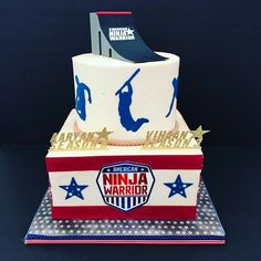 a cake that is on top of a blue and red tablecloth with an american ninja logo