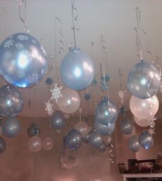 christmas balls and snowflakes hanging from the ceiling