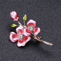 Add a little vintage-inspired charm to your ensemble with this stunning brooch featuring a floral motif. 1.14" W x 2.08" L 18k gold-plated copper / enamel / cubic zirconia Pink Enamel, Lapel Pins, Floral Motif, Apparel Accessories, Cubic Zirconia, Vintage Inspired, Jewelry Accessories, 18k Gold, Copper