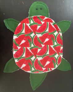 a paper cut out of a turtle with watermelon slices on it